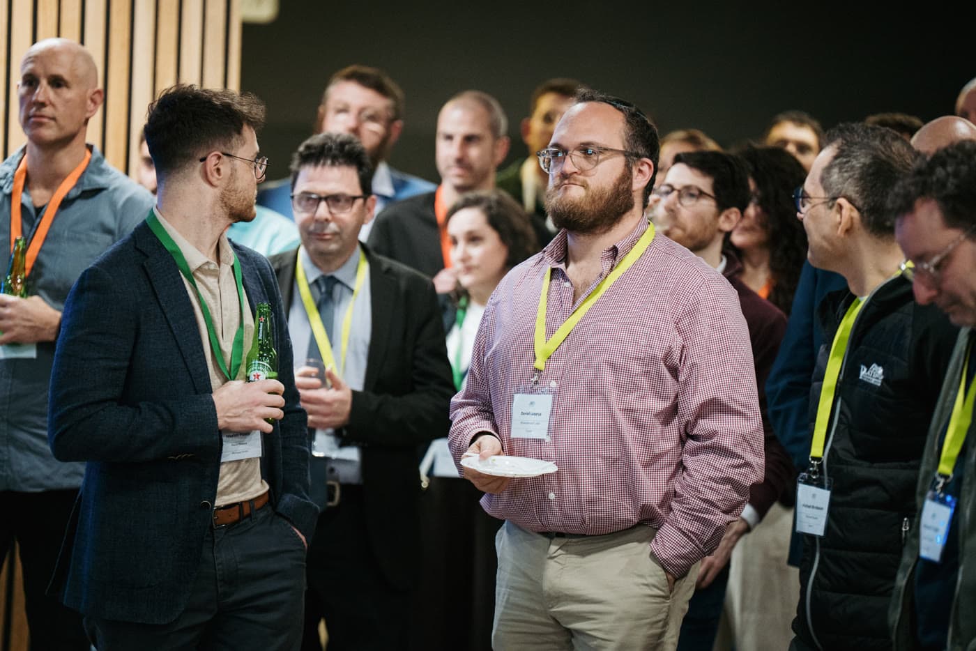 Members listening together, drinks in hand